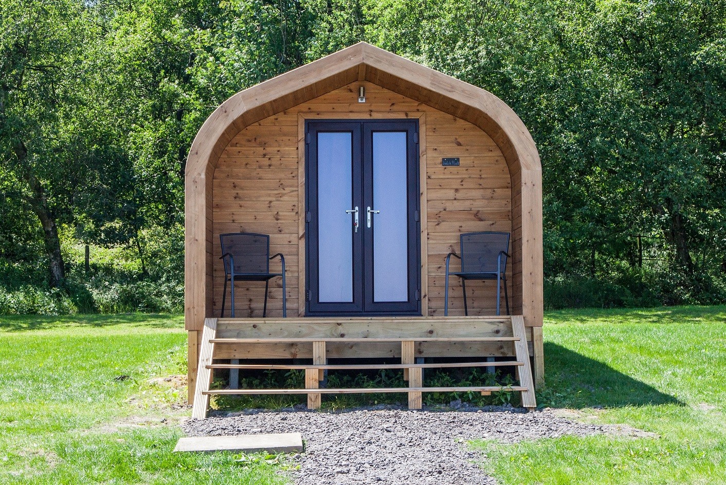 Glamping Pod surrounded by chairs