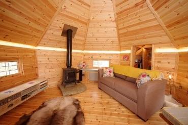 Interior of an extended camping cabins fitted with log burner